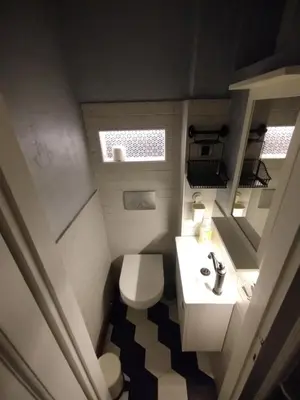 a small bathroom with a toilet and a sink at Vuk i Vojvoda in Belgrade