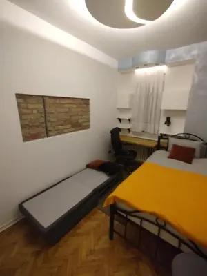 a room with two beds and a desk in it at Vuk i Vojvoda in Belgrade