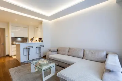 a living room with a couch and a table at Bw Lux Apartments River view in Belgrade