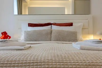 a bedroom with a bed with towels on it at Bw Lux Apartments River view in Belgrade