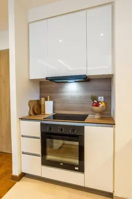 a kitchen with white cabinets and a stove at Bw Lux Apartments River view in Belgrade