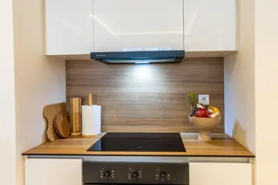 a kitchen with a stove and a bowl of fruit at Bw Lux Apartments River view in Belgrade