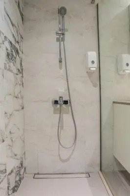 a shower with a shower head in a bathroom at Bw Lux Apartments River view in Belgrade