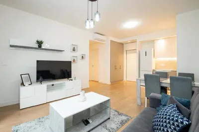 a living room with a couch and a tv at BW Terra Lux in Belgrade