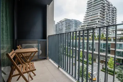 a balcony with a table and chairs and buildings at BW Terra Lux in Belgrade