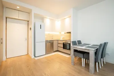 a kitchen with a table and chairs and a refrigerator at BW Terra Lux in Belgrade