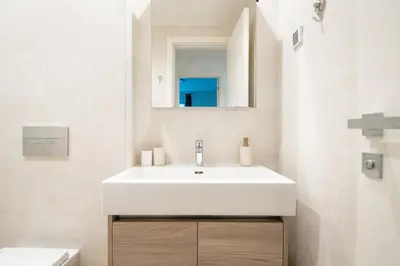 a bathroom with a white sink and a mirror at BW Terra Lux in Belgrade
