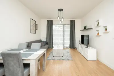 a white living room with a table and a couch at BW Terra Lux in Belgrade