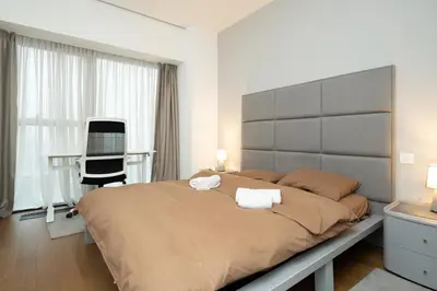 a bedroom with a large bed and a desk at West Kula 17 in Belgrade