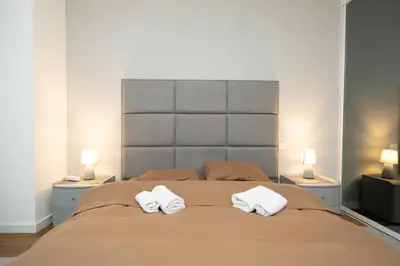 a bedroom with a large bed with two white towels at West Kula 17 in Belgrade