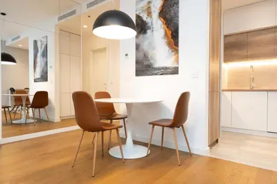 a dining room with a white table and chairs at West Kula 17 in Belgrade
