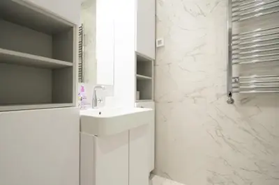 a white bathroom with a sink and a shower at West Kula 17 in Belgrade