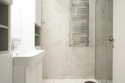a white bathroom with a shower and a sink at West Kula 17 in Belgrade