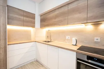 a kitchen with white cabinets and a sink at West Kula 17 in Belgrade