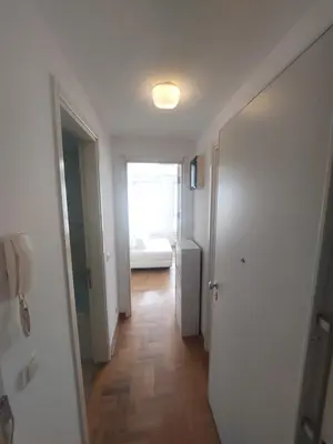 a hallway with a door and a room with a window at DELTA CITY apartments in Novi Beograd