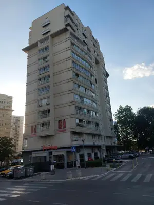 a tall building on the corner of a street at DELTA CITY apartments in Novi Beograd