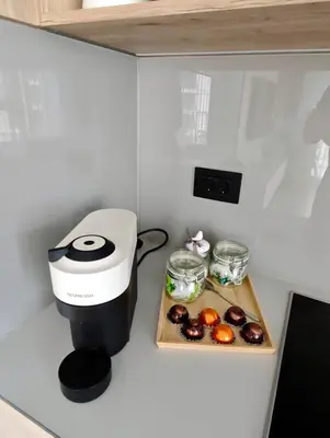 a coffee maker on a counter next to a tray of food at Belgrade Waterfront Primestay in Belgrade