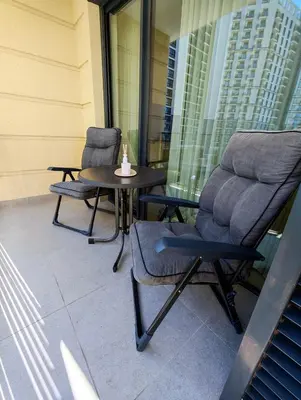 two chairs and a table on a balcony at Belgrade Waterfront Primestay in Belgrade
