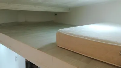 a mattress sitting on the floor of a room at Small Apartment private bathroom ,strong internet in Belgrade