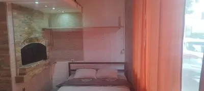 a small bed in a room with a fireplace at Small Apartment private bathroom ,strong internet in Belgrade