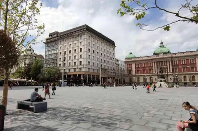 a group of people walking around a large plaza at Five Points Square - City Center in Belgrade