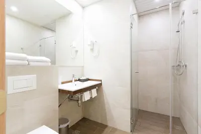 a bathroom with a sink and a shower at Five Points Square - City Center in Belgrade