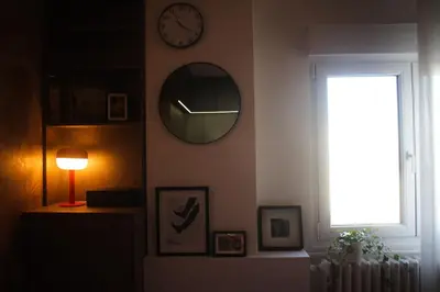 a room with a clock and a mirror on the wall at Center Luxury Studio Knez Mihailova & Kalemegdan in Belgrade