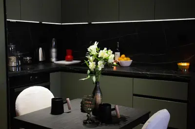 a kitchen with a table with a vase of flowers at Center Luxury Studio Knez Mihailova & Kalemegdan in Belgrade