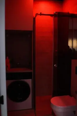 a red bathroom with a toilet and a sink at Center Luxury Studio Knez Mihailova & Kalemegdan in Belgrade