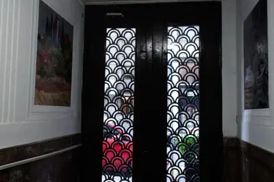 a black door with a patterned window in a hallway at Center Luxury Studio Knez Mihailova & Kalemegdan in Belgrade