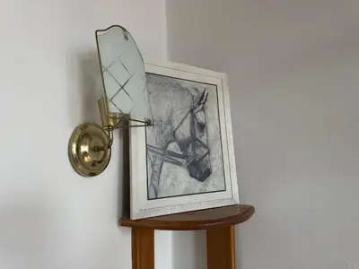 a mirror on a wall next to a picture at Guesthouse Vladimir & Ana in Pančevo
