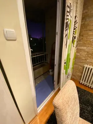 a view of a balcony from a door with a chair at apartman the one - free parking in Belgrade