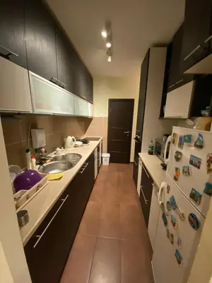 a kitchen with a sink and a refrigerator at apartman the one - free parking in Belgrade