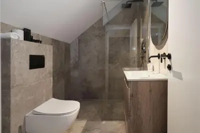 a bathroom with a toilet and a sink at Oasis Pool House