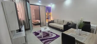 a living room with a couch and a table at Belgrade Dawn Apartment in Belgrade
