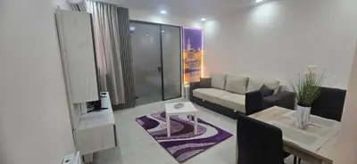a living room with a couch and a table at Belgrade Dawn Apartment in Belgrade