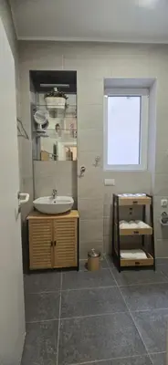 a bathroom with a sink and a mirror at Belgrade Dawn Apartment in Belgrade