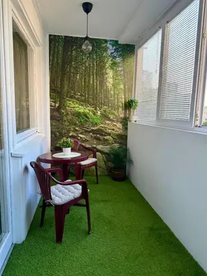 a room with a table and chairs with green carpet at Bright Elegant Cozy Apartment - New Belgrade in Beograd