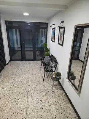 a porch with a chair and a mirror and a table at Viktor in Belgrade