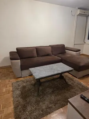 a living room with a brown couch and a coffee table at Viktor in Belgrade