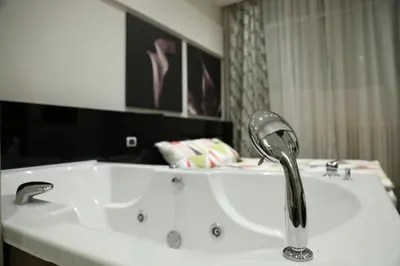 a white bath tub with a faucet in a bathroom at City Place Apartments in Belgrade