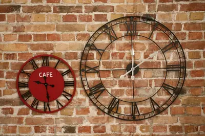 a clock on the side of a brick wall at City Place Apartments in Belgrade