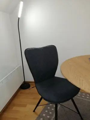 a black chair sitting next to a table with a lamp at Soft Loft cozy studio with a garage parking place in Belgrade