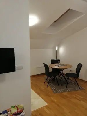 a dining room with a table and chairs at Soft Loft cozy studio with a garage parking place in Belgrade