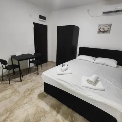 a bedroom with a bed with two towels on it at Hera Apartments in Belgrade