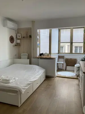 a bedroom with a white bed and a desk at NiNiNo in Belgrade
