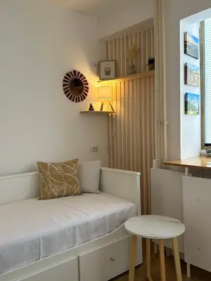 a small room with a bed and a table at NiNiNo in Belgrade