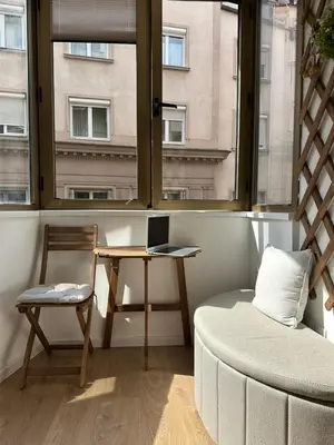 a room with a table and a chair and a window at NiNiNo in Belgrade