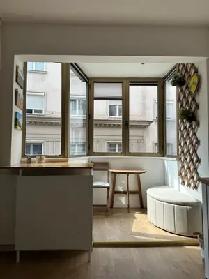 a living room with a table and a large window at NiNiNo in Belgrade