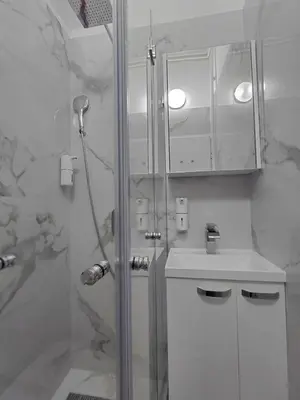 a bathroom with a shower and a sink at Angel Suites in Belgrade